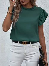 Top sin mangas de color liso con lazo y volantes